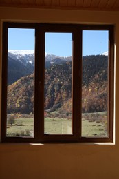 Photo of Beautiful view of mountains from clean window indoors