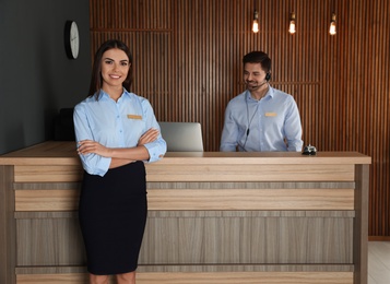 Receptionist at desk with colleague in lobby
