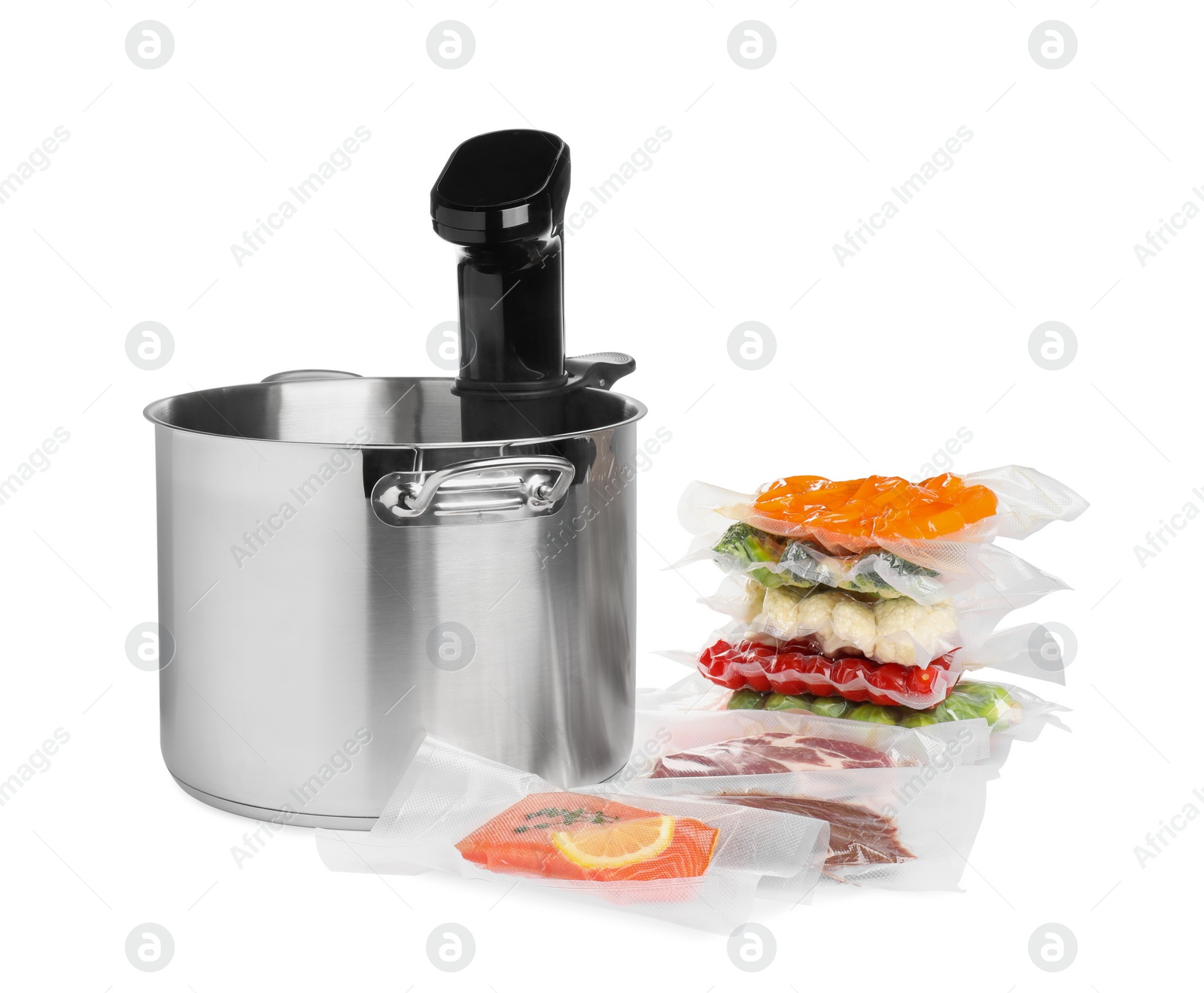 Photo of Thermal immersion circulator in pot and vacuum packs with different food products on white background. Sous vide cooking