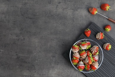 Photo of Flat lay composition with chocolate covered strawberries on grey background