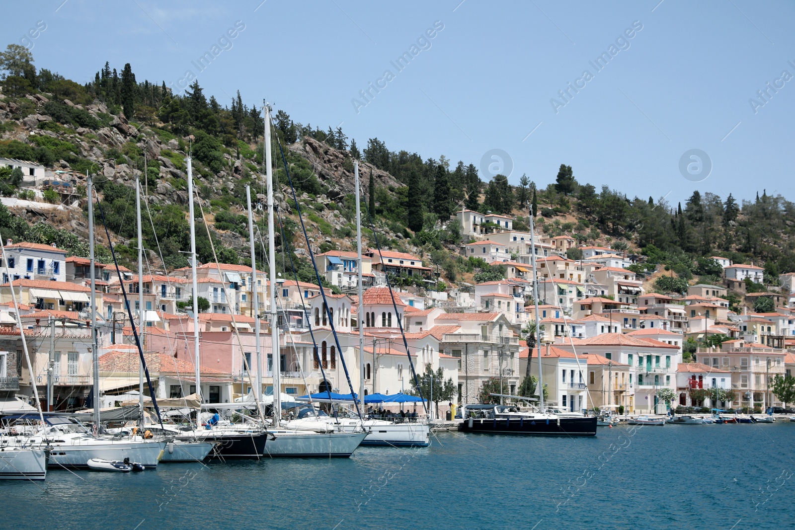 Photo of Beautiful view of coastal city with sailboats on sunny day