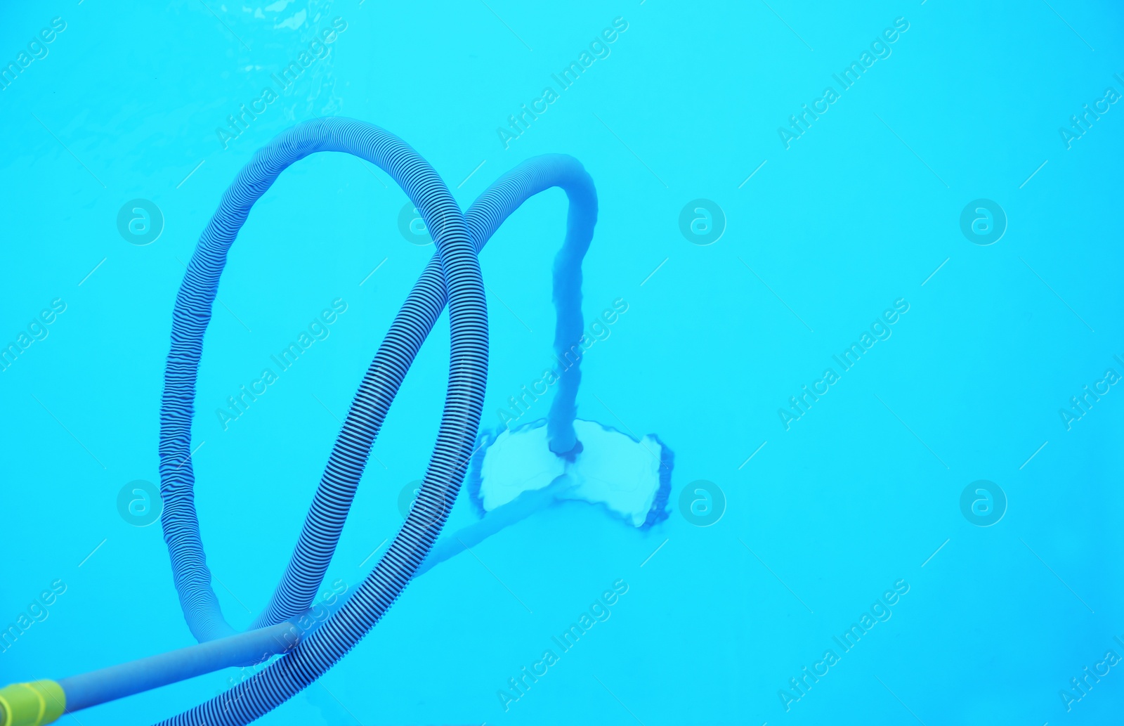 Photo of Cleaning outdoor pool with underwater vacuum, closeup