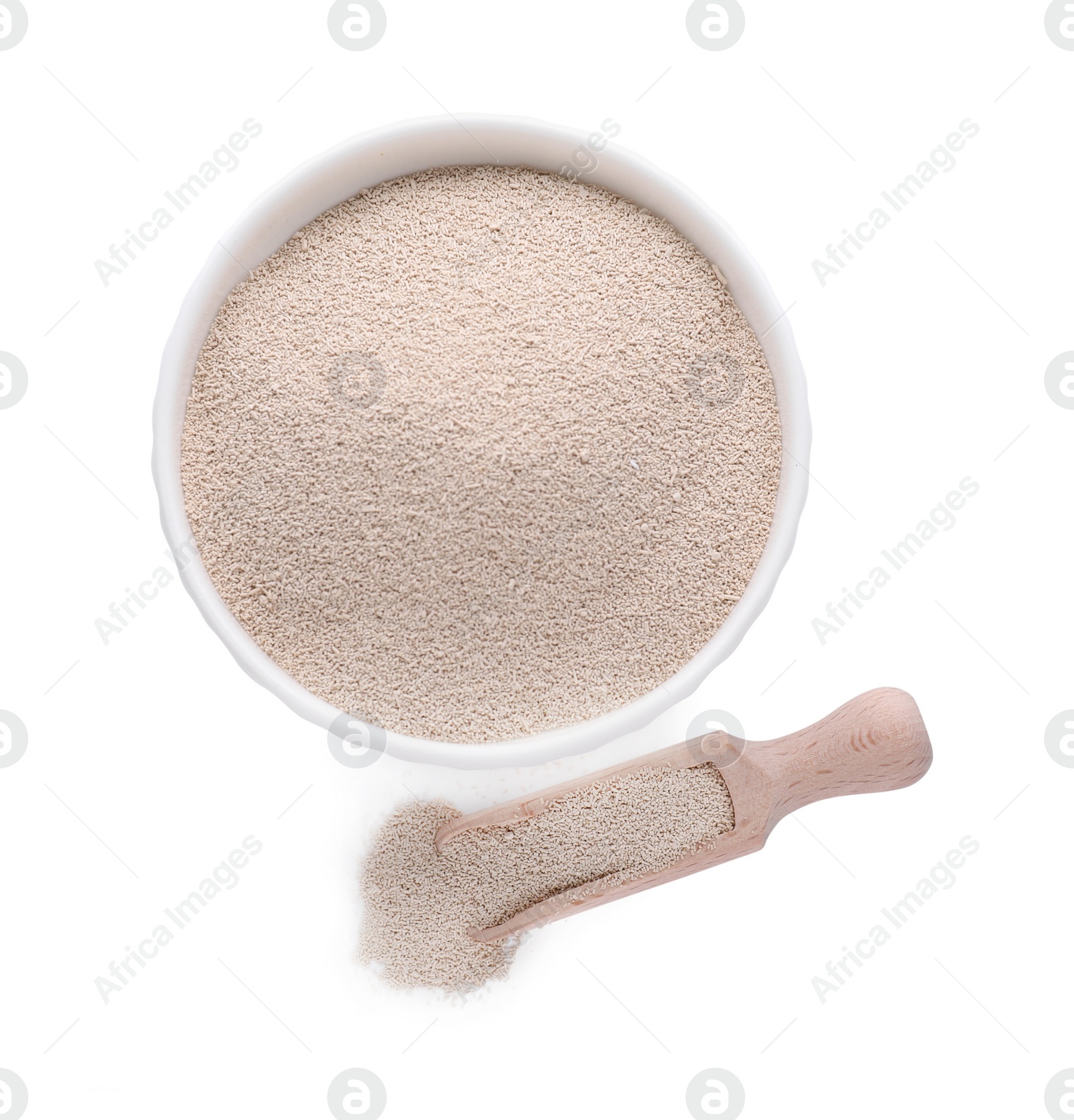 Photo of Bowl and scoop with active dry yeast isolated on white, top view