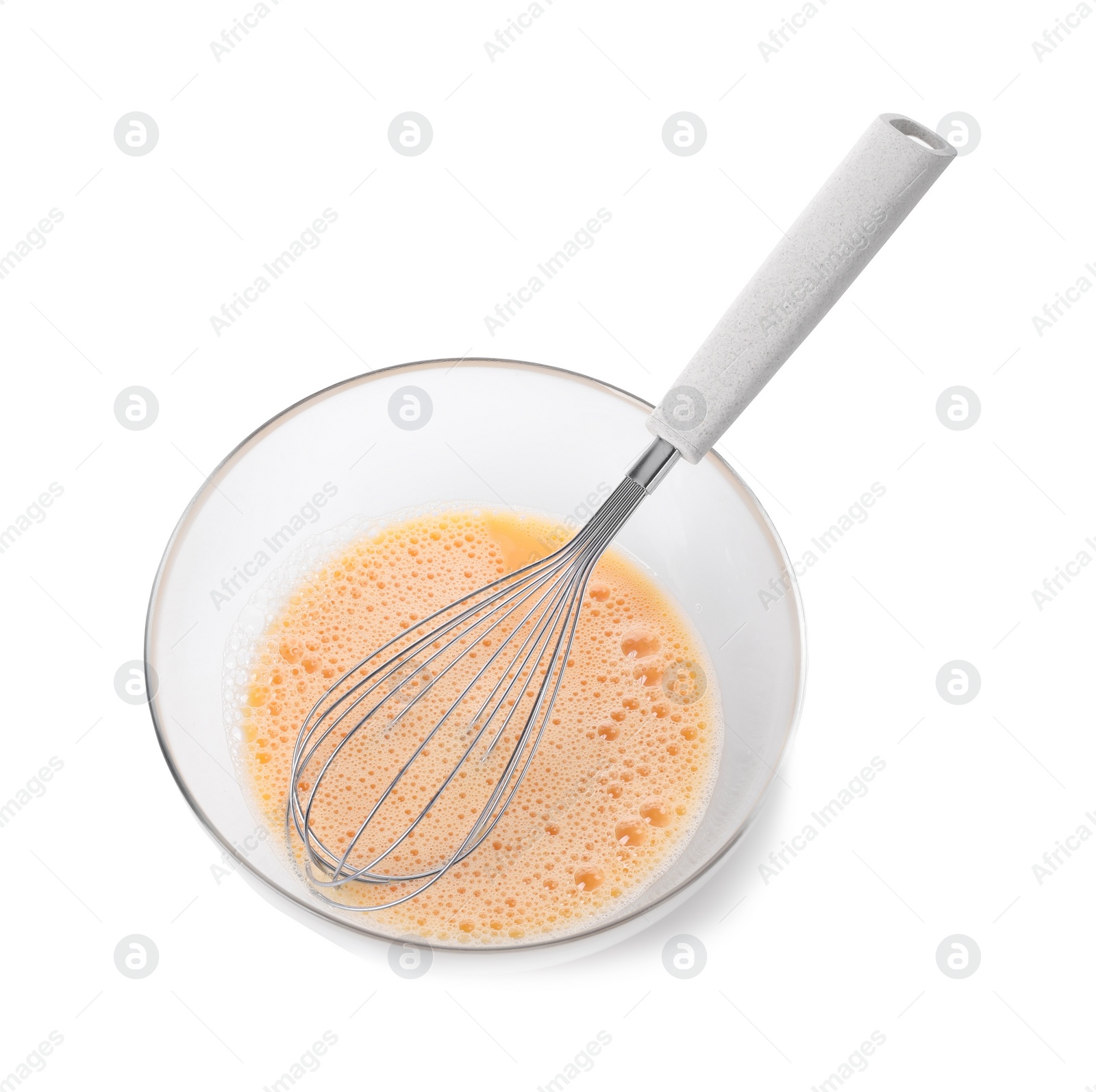 Photo of Beaten eggs and whisk in glass bowl isolated on white