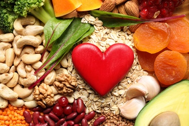 Healthy products and decorative heart, top view