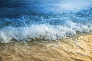 Photo of Beautiful sea waves on beach, closeup view