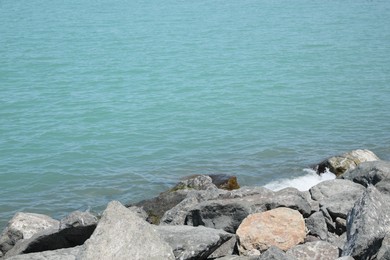 Photo of Beautiful view of sea coast with stones on sunny day