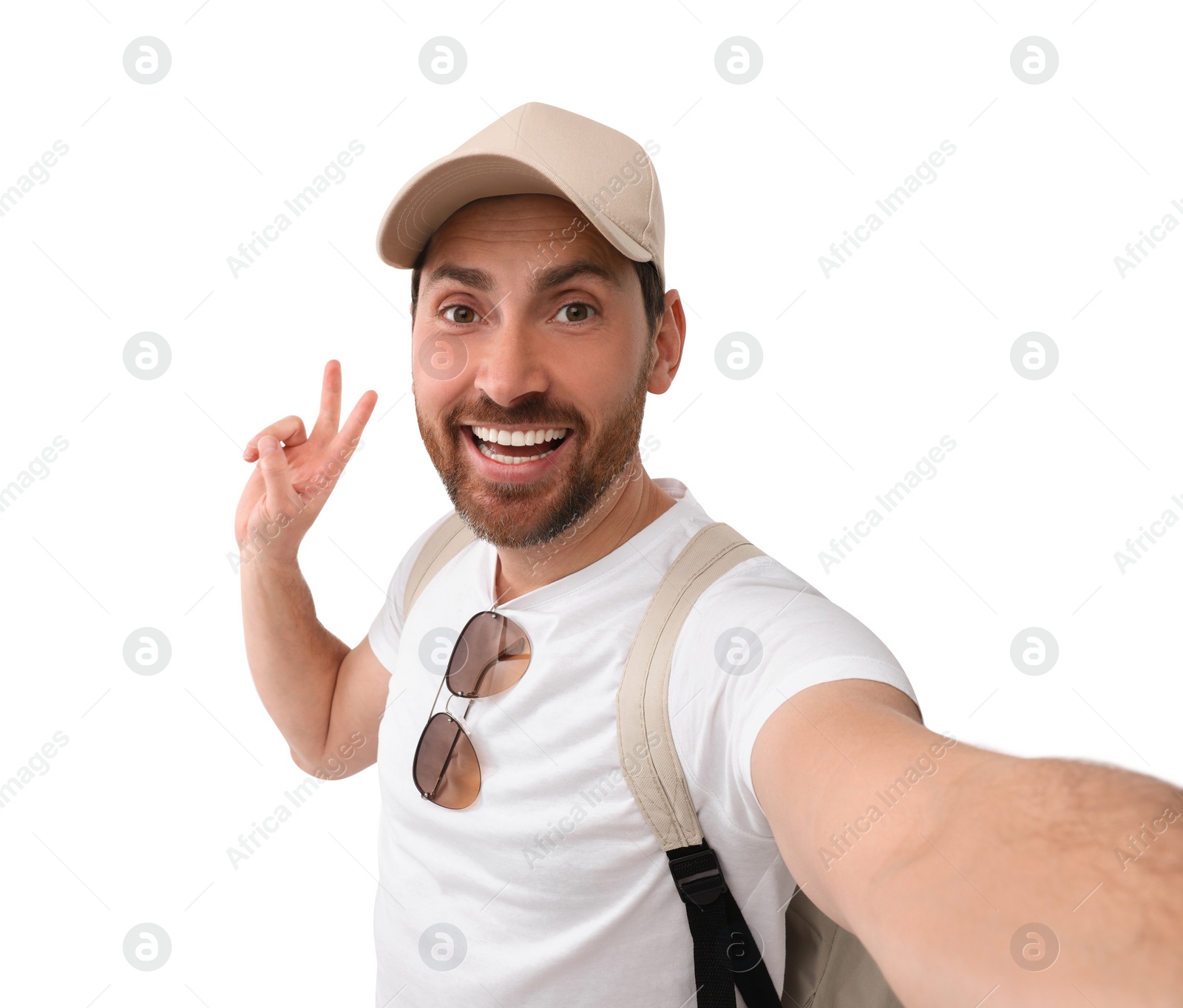 Photo of Smiling man taking selfie and showing peace sign on white background