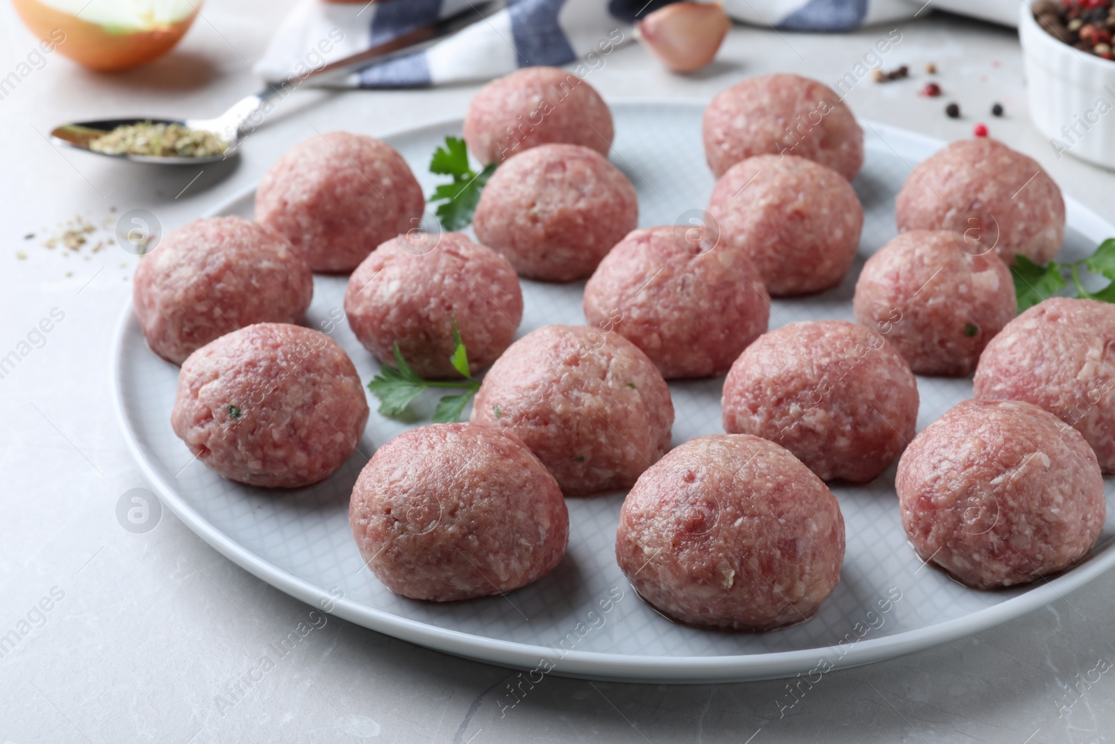 Photo of Many fresh raw meatballs on light table