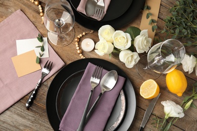 Photo of Elegant festive table setting on wooden background, flat lay