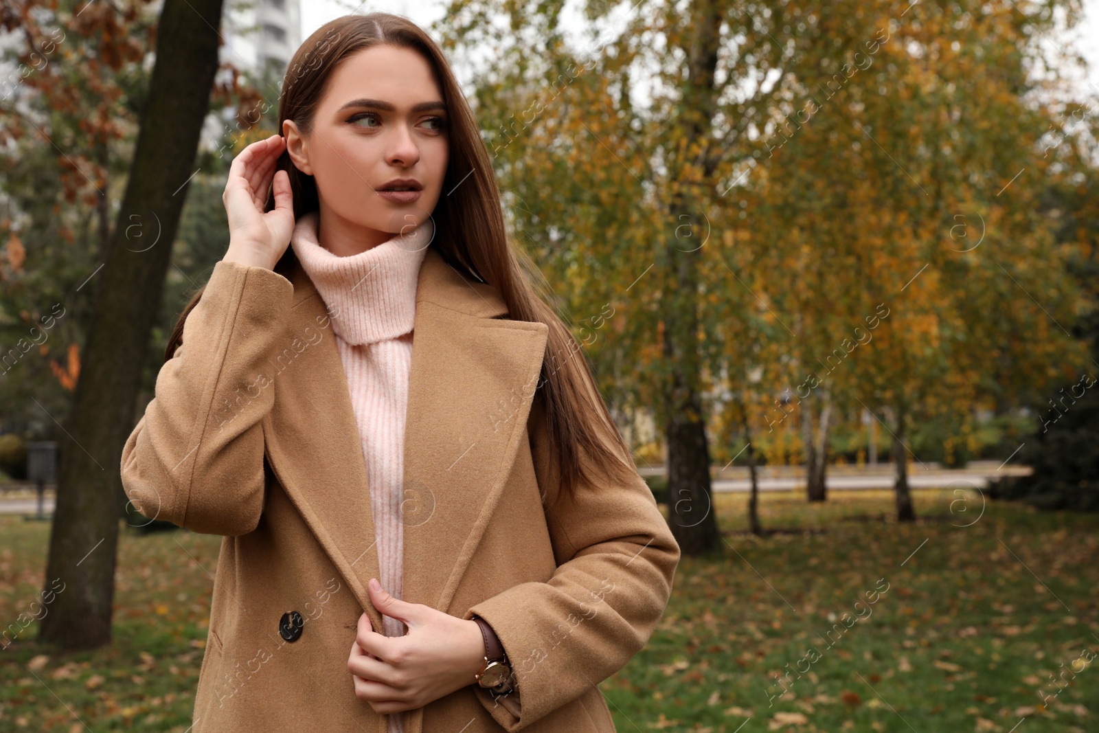 Photo of Beautiful young woman wearing stylish clothes in autumn park