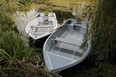 Photo of Modern boats with wooden oars on lake