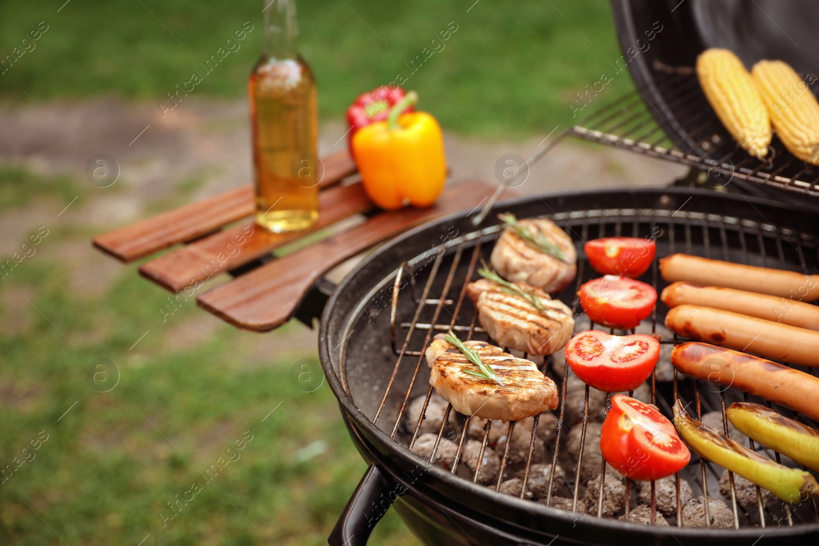 Photo of Barbecue grill with tasty fresh food outdoors