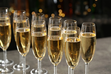 Glasses of champagne on table against blurred background
