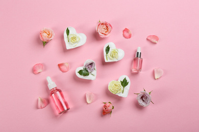 Flat lay composition with natural handmade soap and ingredients on pink background