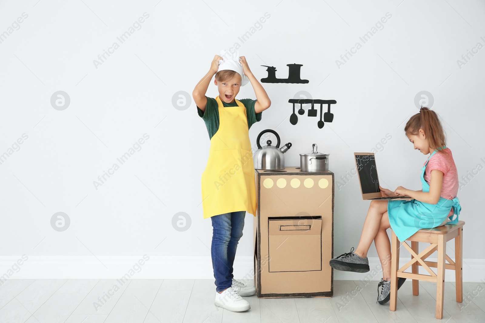 Photo of Little children playing with carton toys indoors