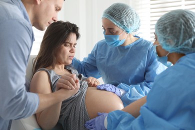 Photo of Woman giving child birth in maternity hospital