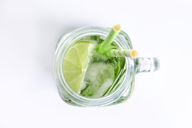 Photo of Natural lemonade with cucumber, lime and rosemary in mason jar on white background, top view