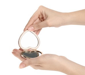 Photo of Woman holding stylish heart shaped cosmetic pocket mirror on white background, closeup