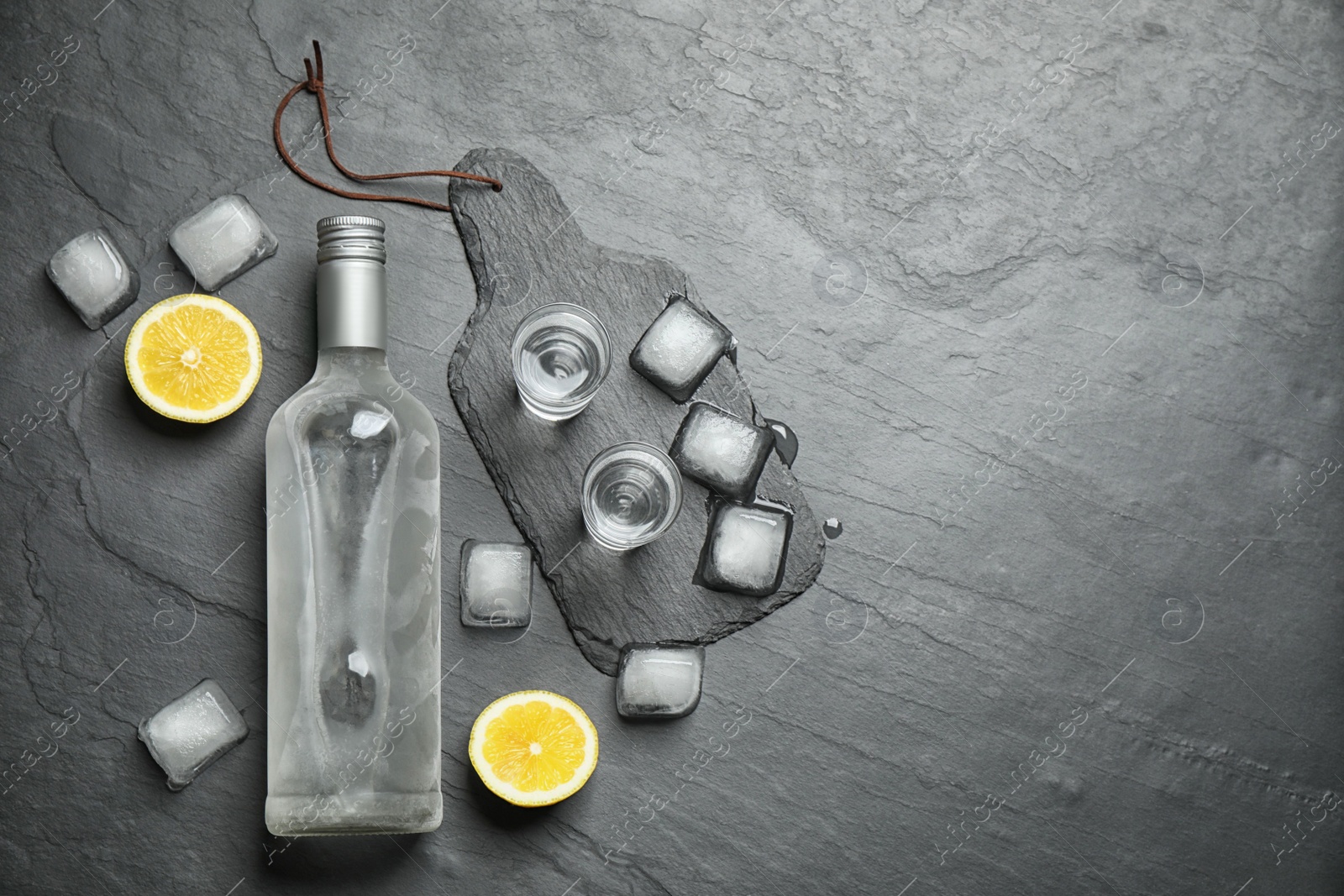 Photo of Flat lay composition with cold Russian vodka on black table. Space for text