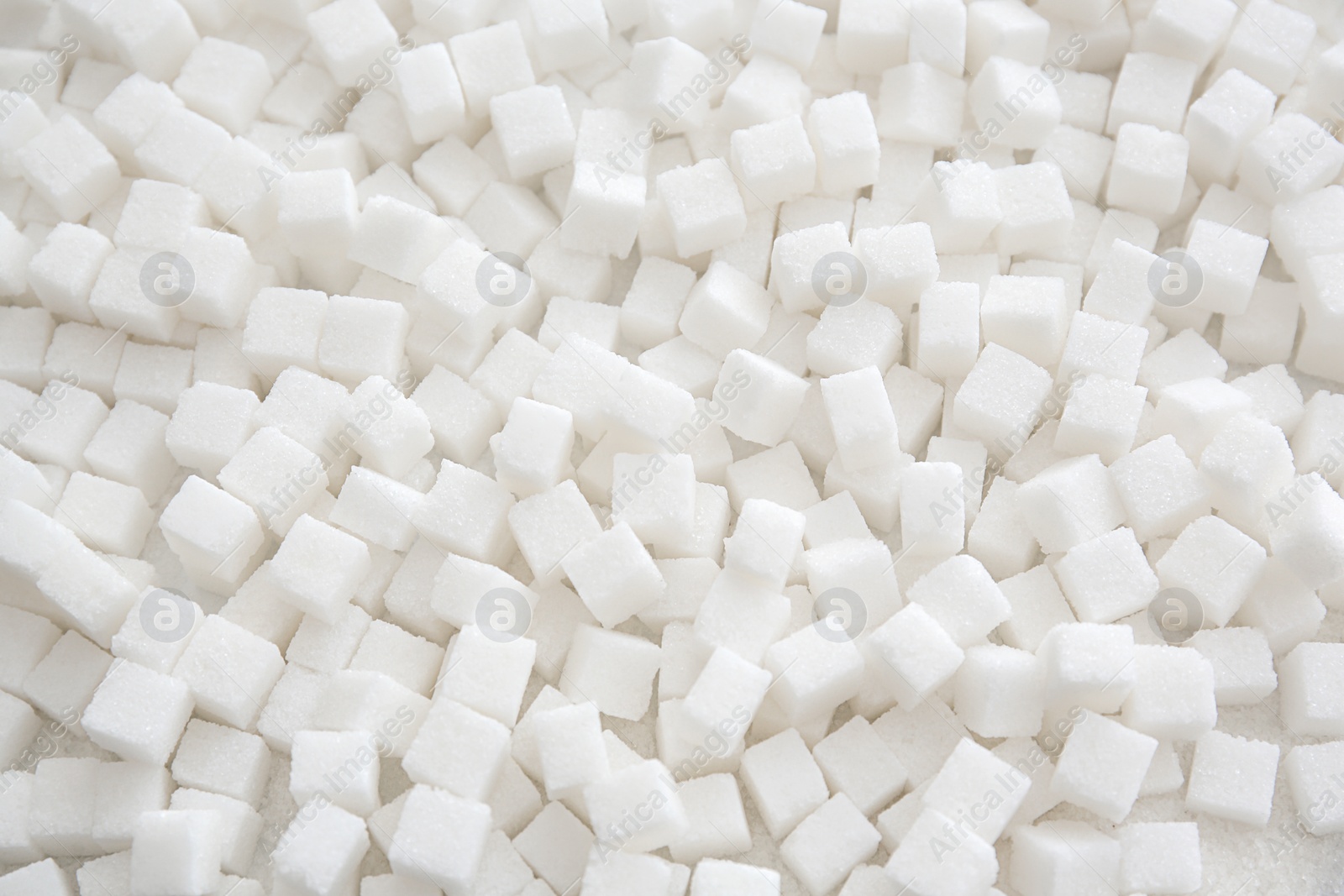 Photo of Refined sugar cubes as background, top view