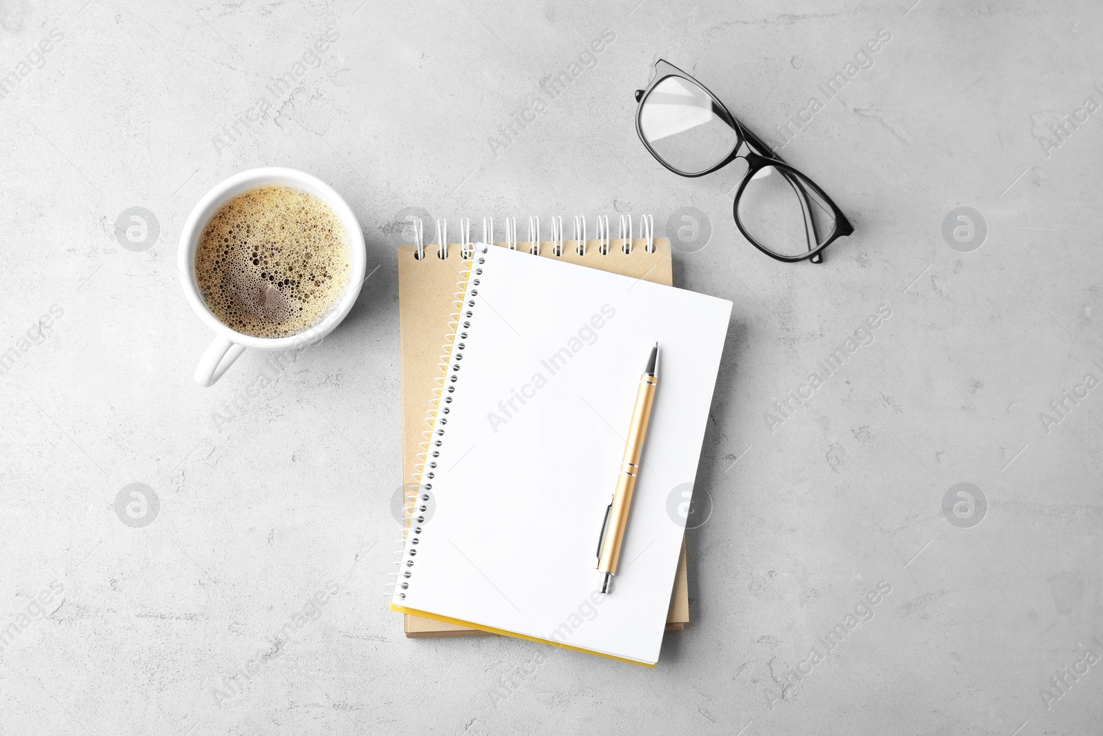 Photo of Flat lay composition with office stationery and cup of coffee on light stone background