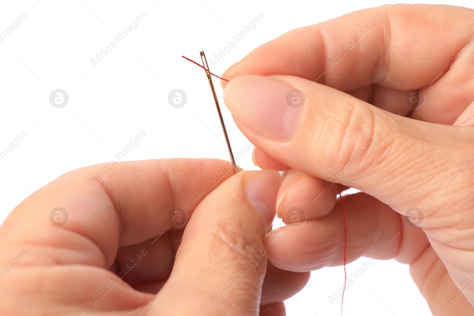 Photo of Woman threading sewing needle on white background, closeup