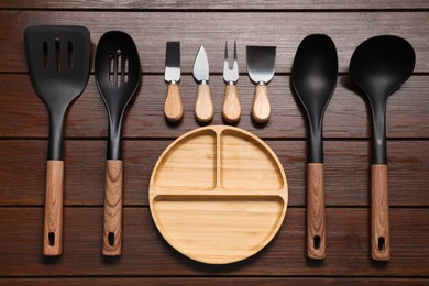 Set of different kitchen utensils on wooden table, flat lay
