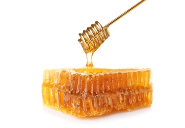 Photo of Pouring honey onto fresh comb on white background