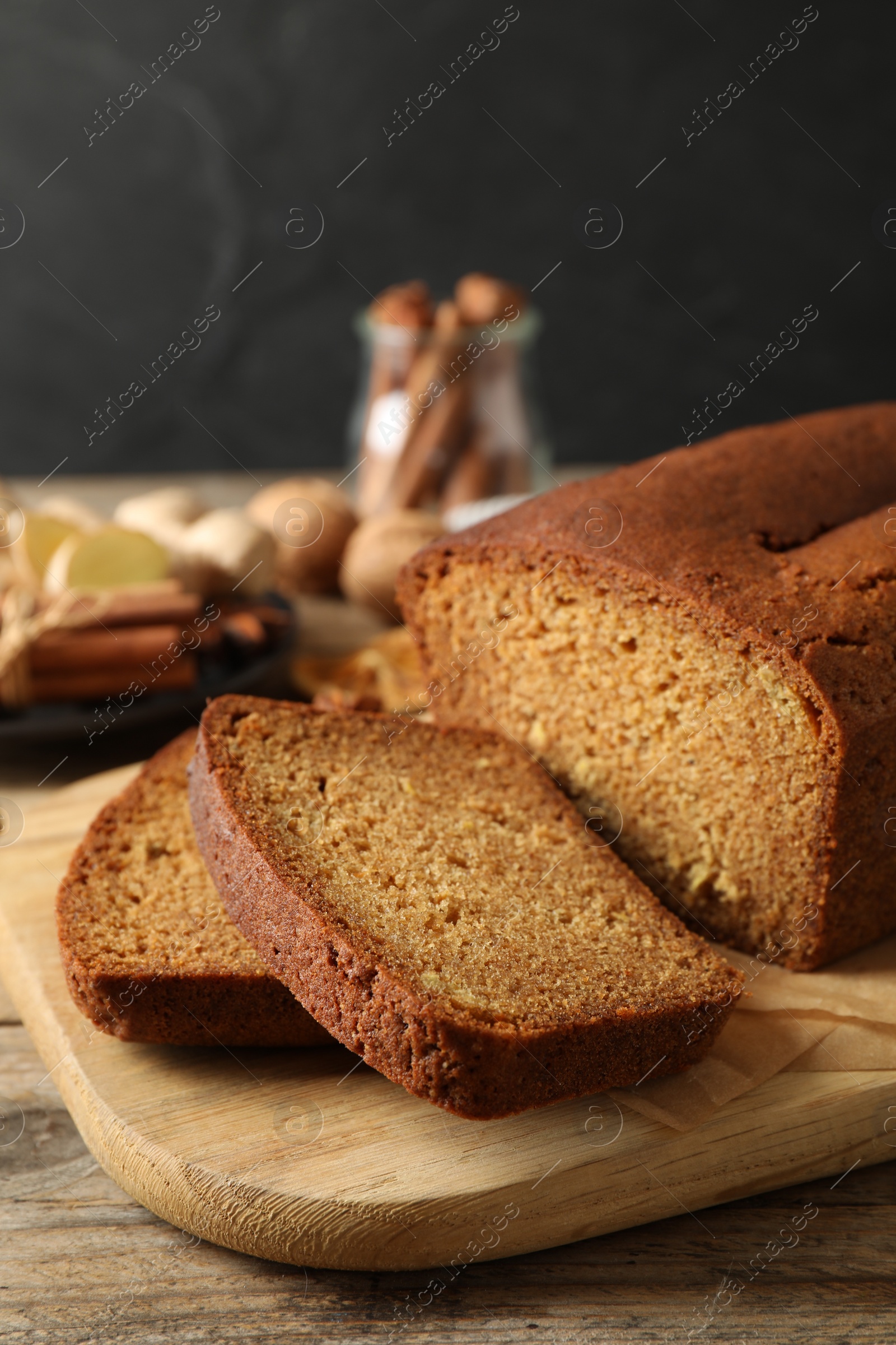 Photo of Fresh sliced gingerbread cake on wooden table