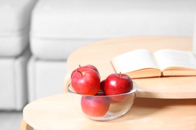 Photo of Bowl of fresh red apples on table indoors. Space for text