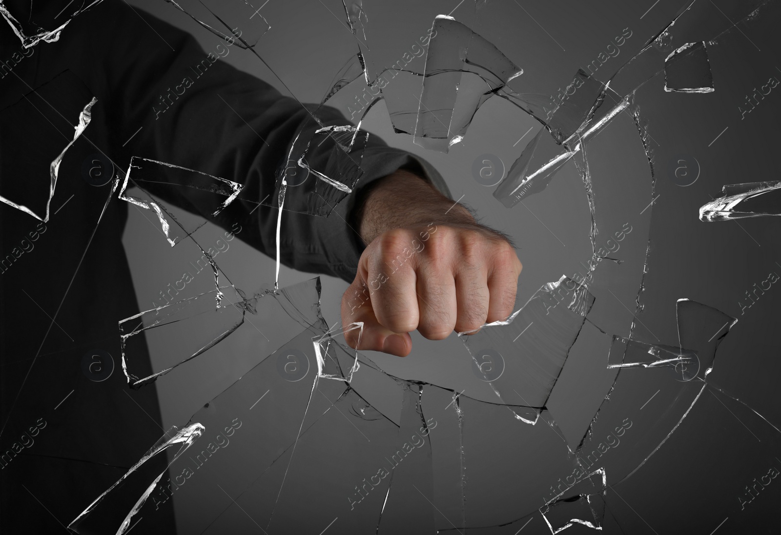 Image of Man breaking window with fist on grey background, closeup