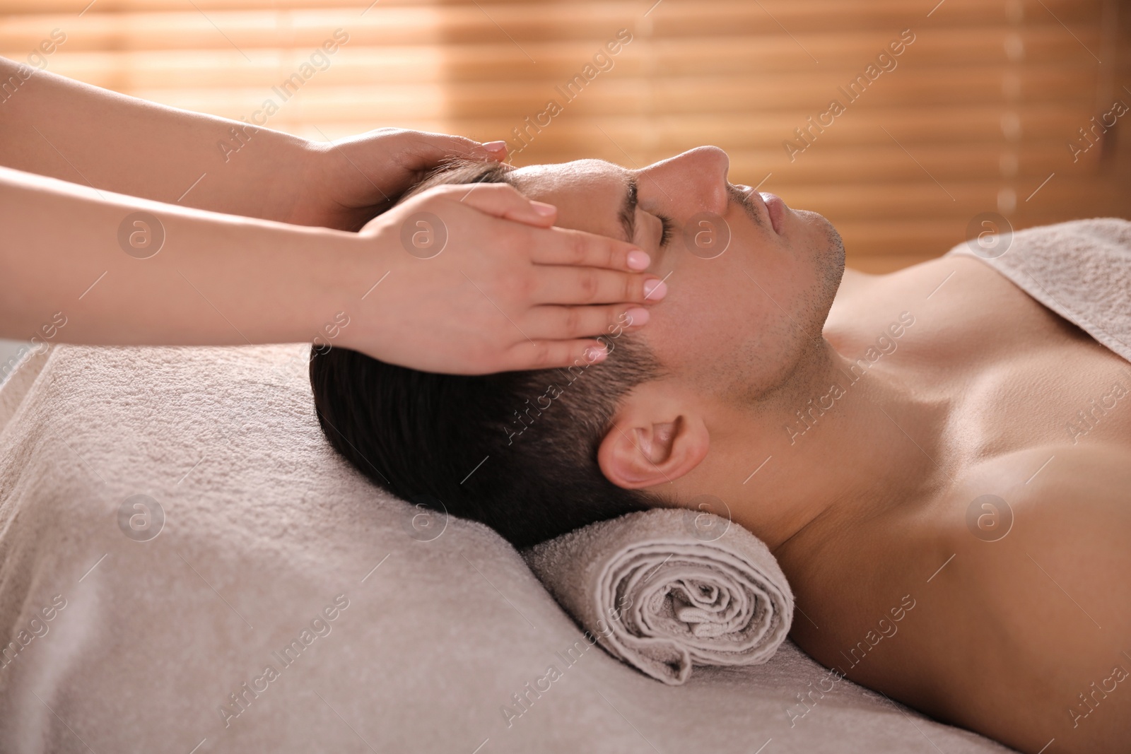 Photo of Man receiving facial massage in beauty salon