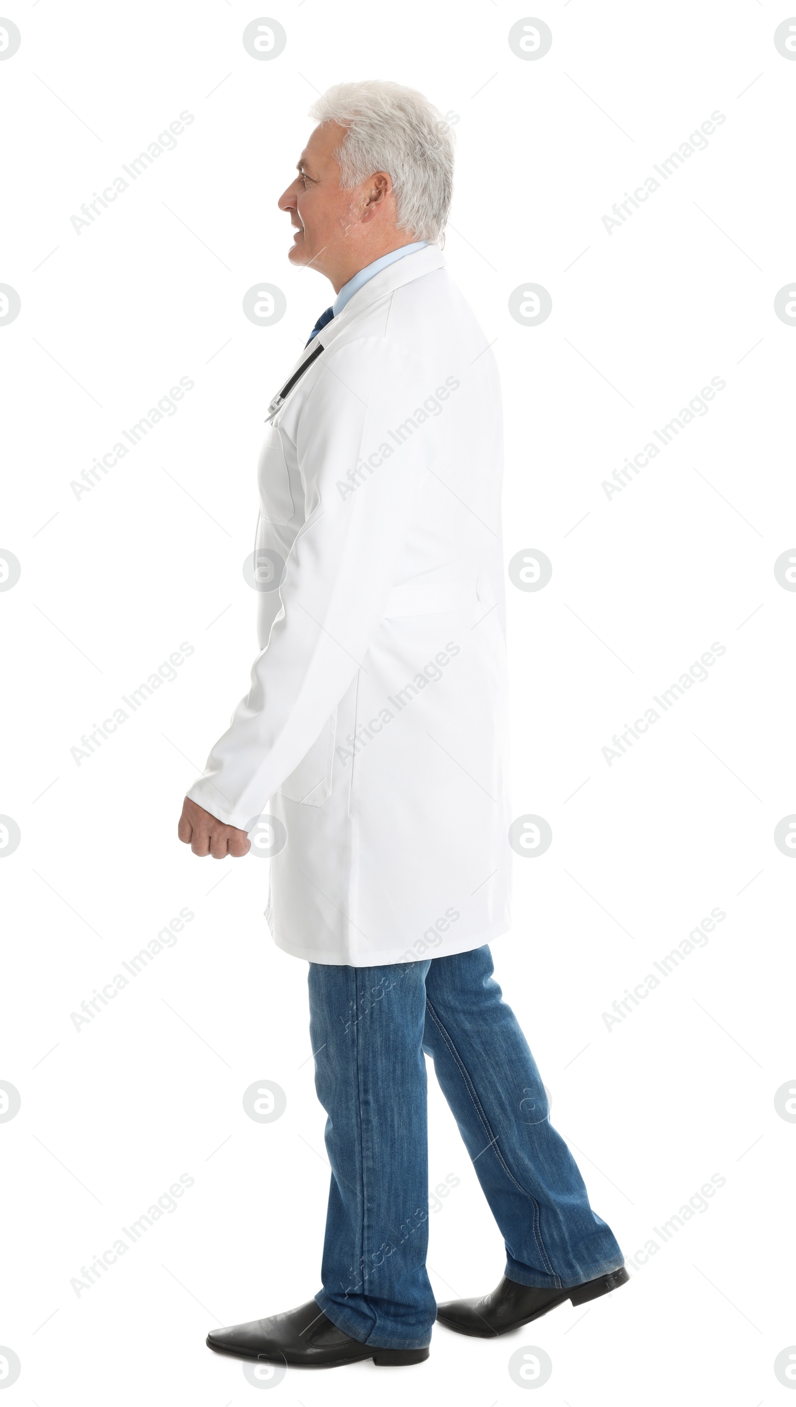 Photo of Full length portrait of senior doctor walking on white background