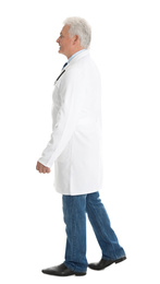 Photo of Full length portrait of senior doctor walking on white background