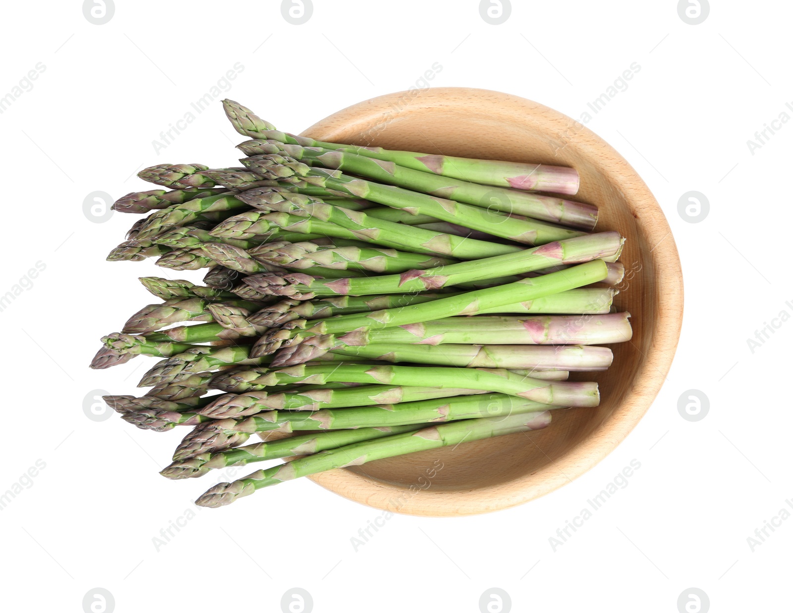 Photo of Fresh raw asparagus in wooden bowl isolated on white, top view