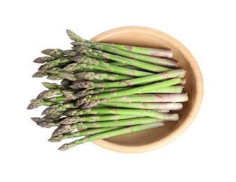 Photo of Fresh raw asparagus in wooden bowl isolated on white, top view