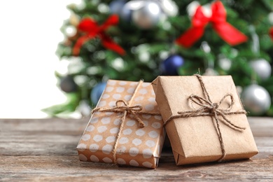 Photo of Beautiful gift boxes and blurred Christmas tree on background