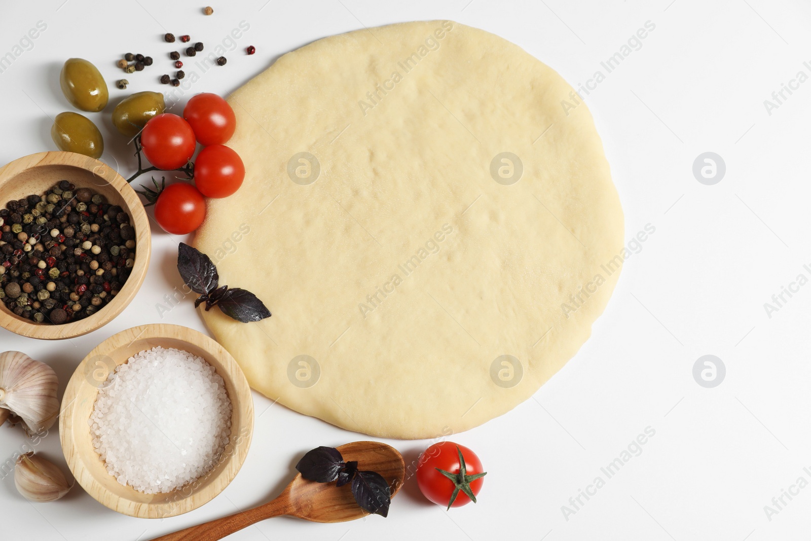 Photo of Fresh pizza dough and products on white background, flat lay. Space for text