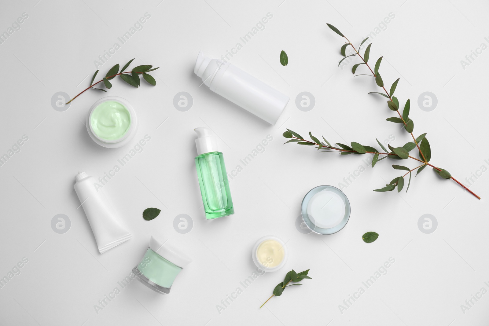 Photo of Flat lay composition with cosmetic products on light background