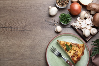 Photo of Delicious pie with mushrooms and cheese served on brown wooden table, flat lay. Space for text