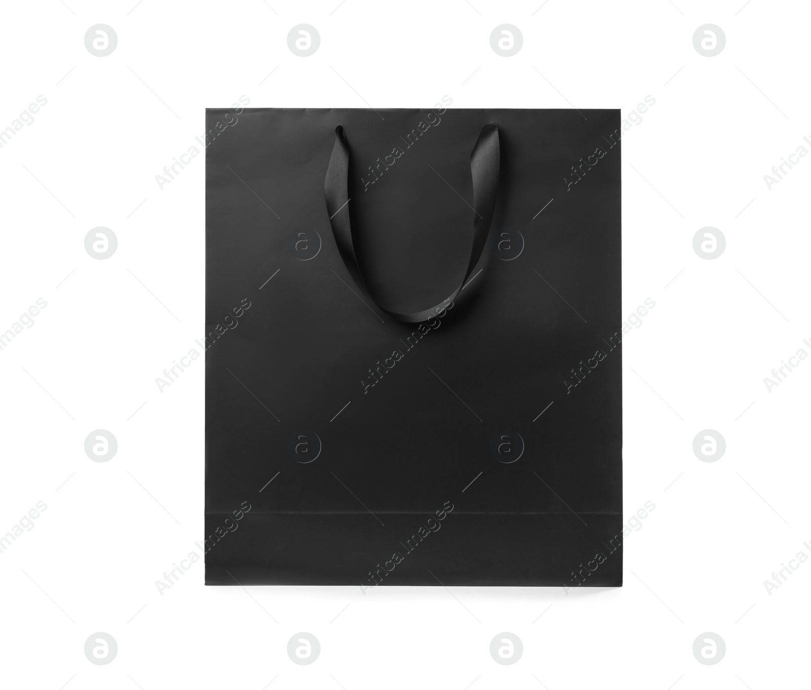 Photo of Paper shopping bag with ribbon handles on white background. Mockup for design