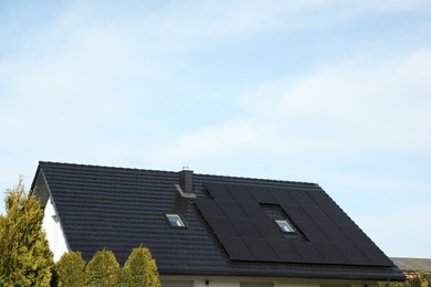 Photo of House with installed solar panels on roof, space for text. Alternative energy