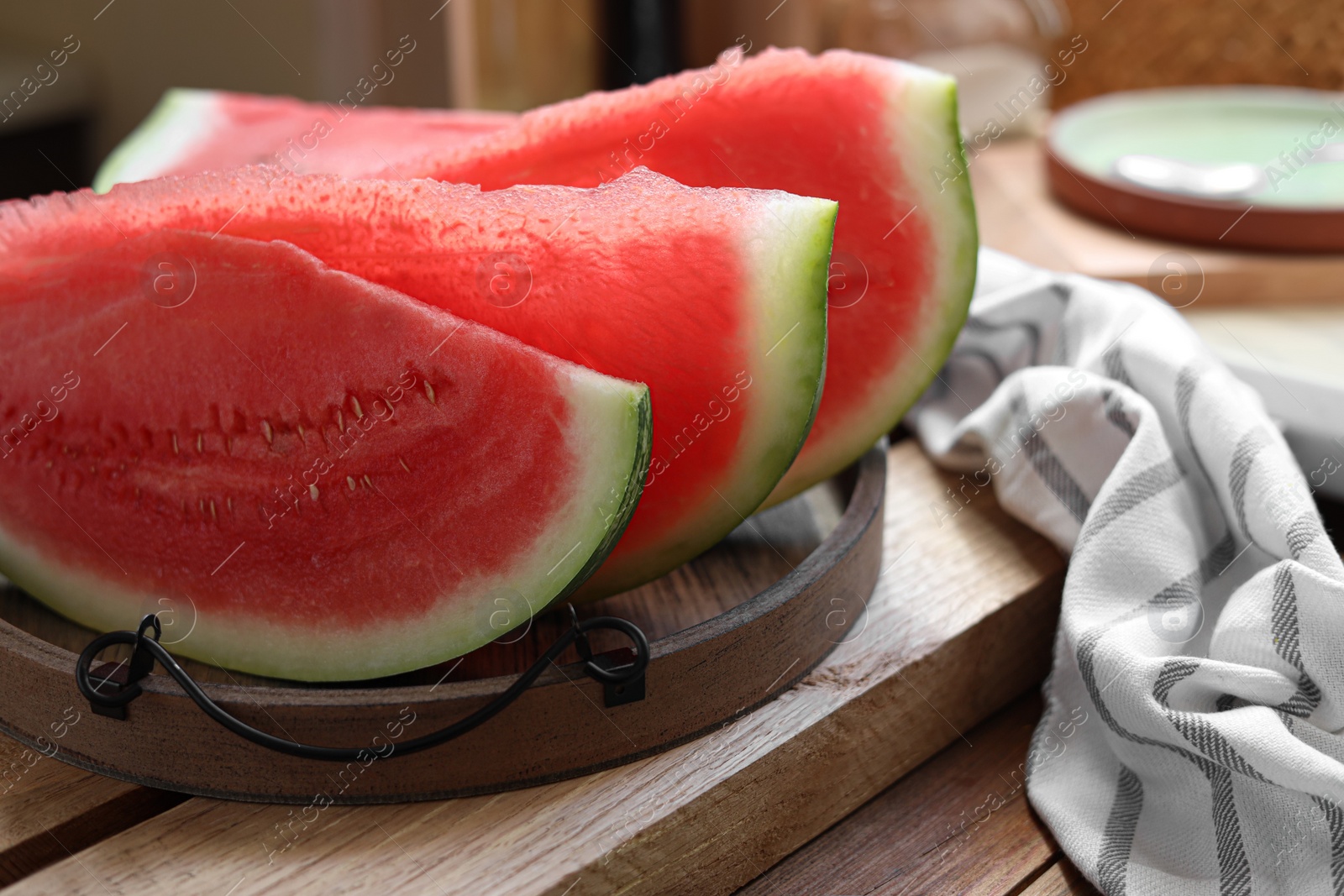 Photo of Sliced fresh juicy watermelon on wooden table, closeup