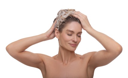 Beautiful woman washing hair on white background