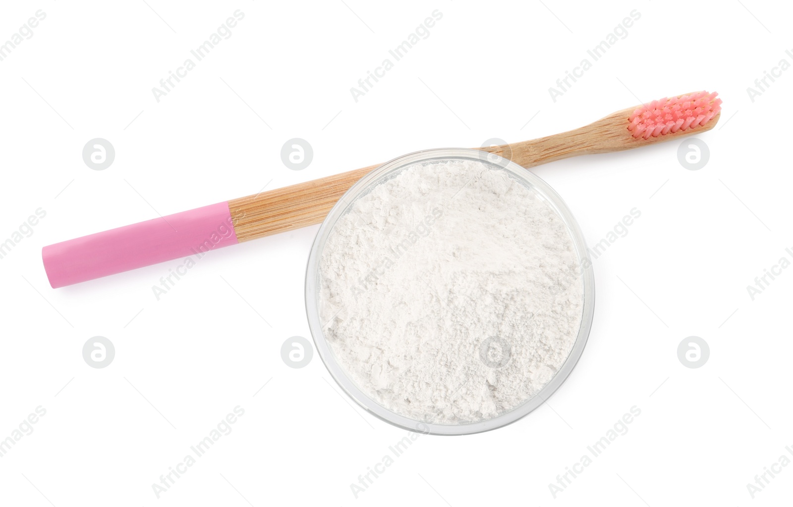 Photo of Bowl of tooth powder and brush on white background, top view