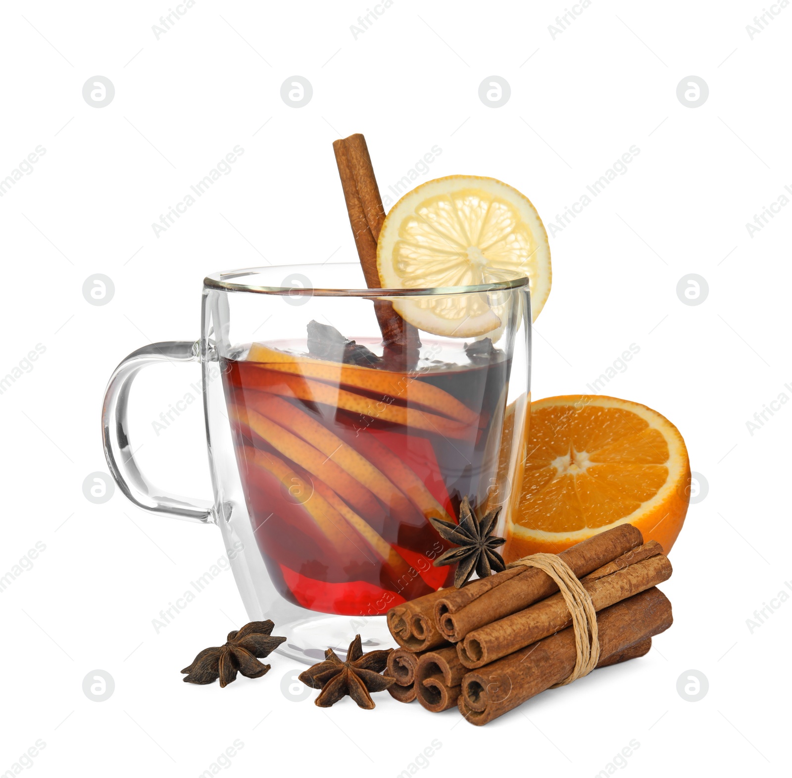 Photo of Glass cup of mulled wine, fresh orange, cinnamon sticks and lemon isolated on white