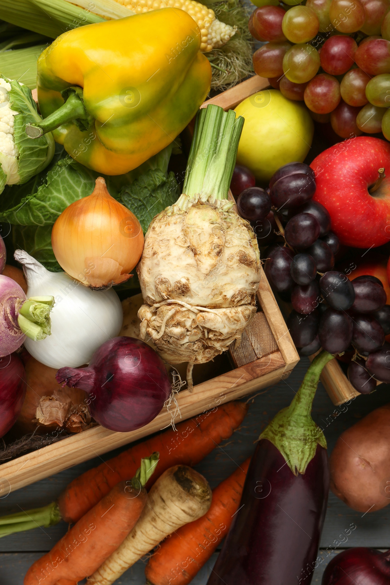 Photo of Different fresh vegetables and fruits with crate on grey wooden table, top view. Farmer harvesting