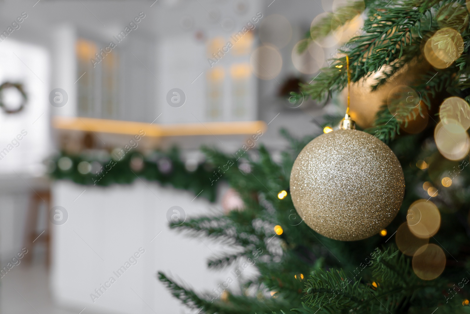 Photo of Closeup view of beautiful decorated Christmas tree in kitchen. Space for text