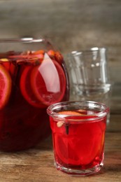 Photo of Aromatic punch drink with citrus fruits on wooden table